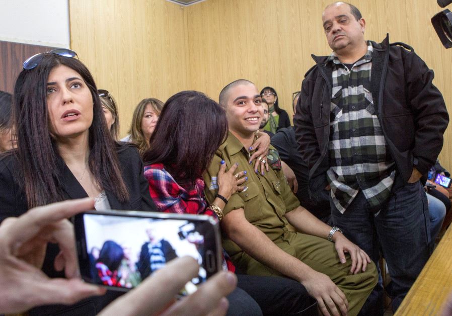 Elor Azaria is embraced by his mother as his father stands nearby, at the start of is sentencing hearing at a military court in Tel Aviv, Israel February 21, 2017 (Reuters)