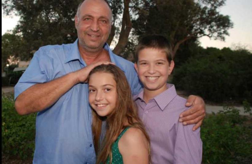 Zevik Etzion, son of Moshe Etzion who took his life on Sunday, with his children (photo credit: IDF WIDOWS AND ORPHANS ORGANIZATION)