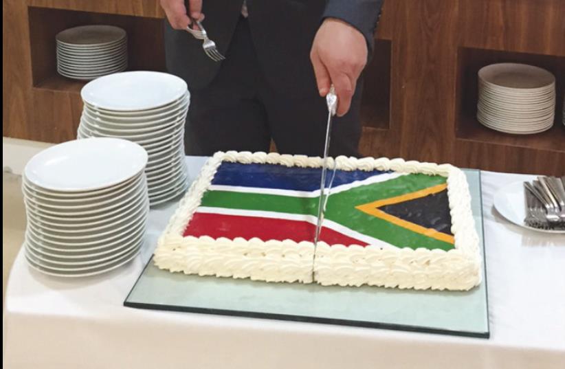 A HOTEL STAFFER cuts a cake at the event in Ramallah on Tuesday. (photo credit: SETH J. FRANTZMAN)