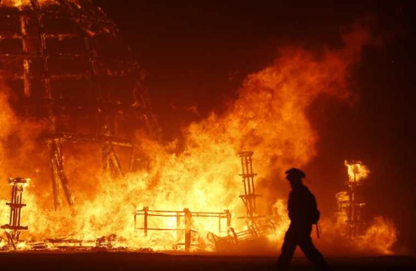 The Temple of Grace burns on the last day of the Burning Man 2014 "Caravansary" arts and music festival in the Black Rock Desert of Nevada (photo credit: REUTERS)