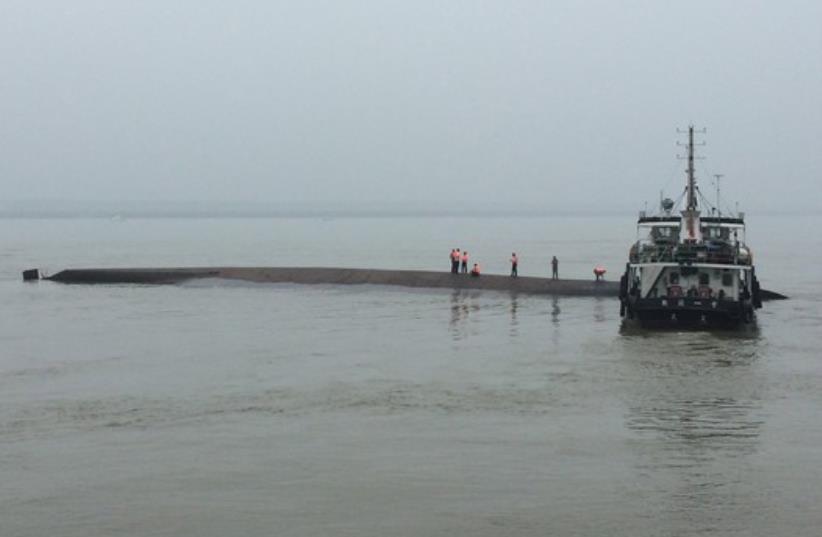 Rescue workers search on a sunken ship in the Jianli section of Yangtze River, Hubei province, China, June 2 (photo credit: REUTERS)