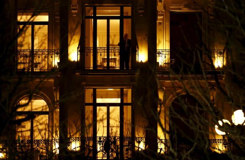 A member of a delegation talks on the phone in the Beau Rivage Palace Hotel during a break in the Iran nuclear program talks in Lausanne March 31, 2015  (photo credit: REUTERS)