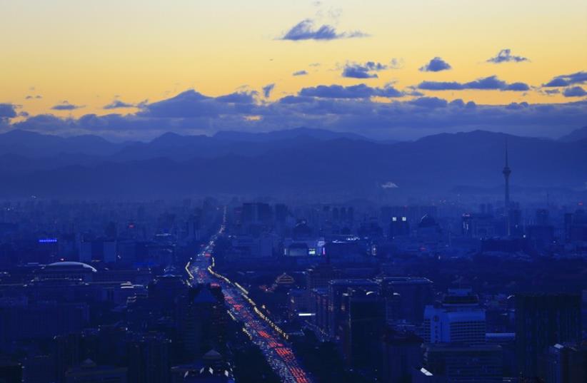 A view of the city's skyline from the Beijing Yintai Centre building at sunset in Beijing (photo credit: REUTERS)