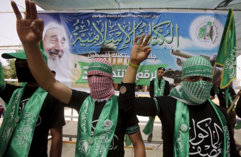 Palestinian students supporting Hamas demonstrate in the West Bank city of Hebron (photo credit: REUTERS)