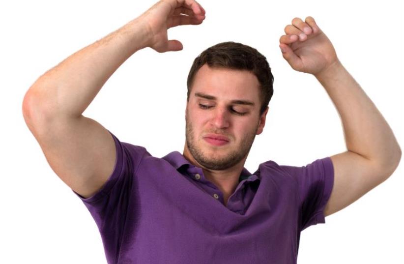 Man with Hyperhidrosis sweating very badly under armpit (photo credit: INGIMAGE)