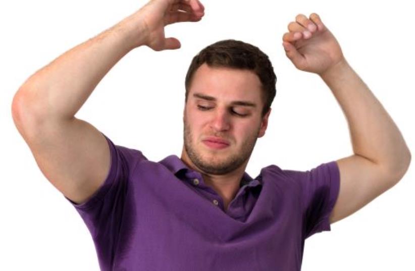 Man with Hyperhidrosis sweating very badly under armpit (photo credit: INGIMAGE)