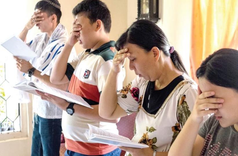 Indonesian Jews reciting the Shema prayer during Saturday morning services. (photo credit: ANNA CLARE SPELMAN)