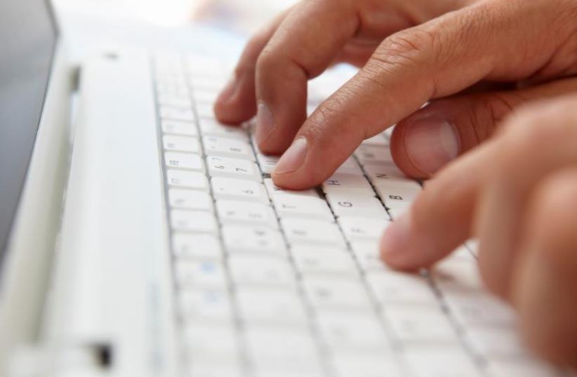 Writing on a computer keyboard [Illustrative] (photo credit: INGIMAGE)