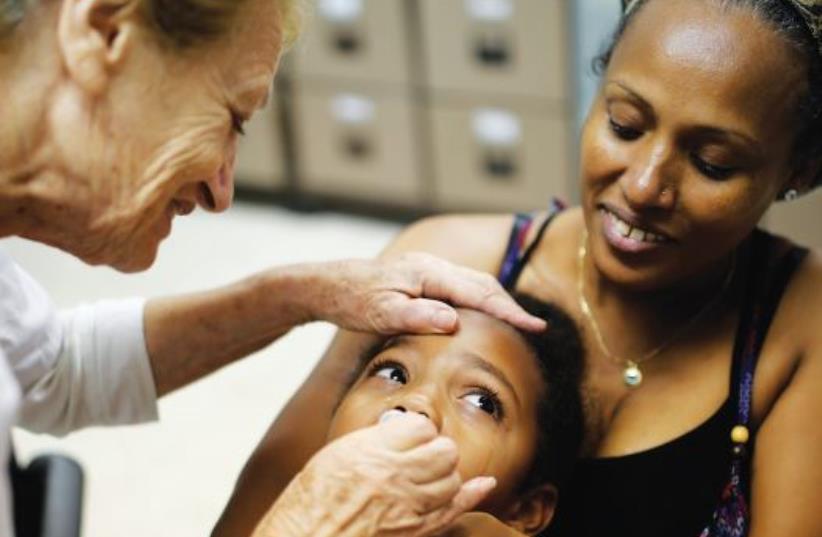 AN ISRAELI CHILD receives the polio vaccine in 2013 (photo credit: REUTERS)