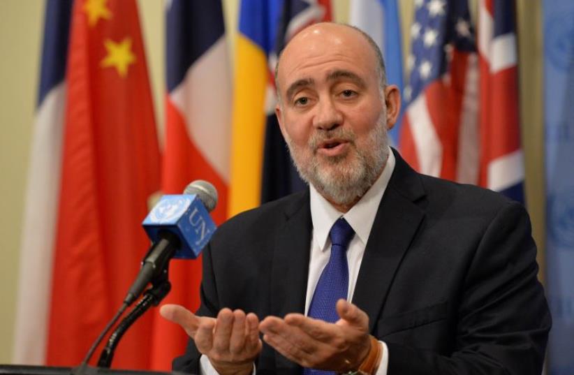 Ron Prosor, then Israel's ambassador to the United Nations, speaks to the media outside the Security Council chambers July 20, 2014 (photo credit: AFP / STAN HONDA)