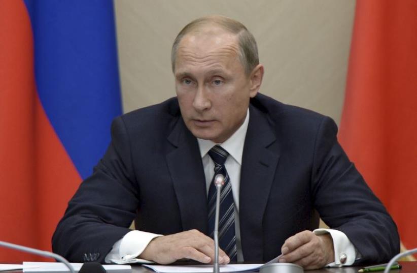 Russian President Vladimir Putin chairs a meeting with members of the government at the Novo-Ogaryovo state residence outside Moscow (photo credit: REUTERS)