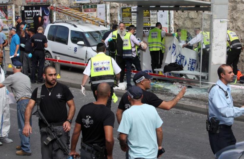 Scene of the ramming and stabbing attack in the ultra-Orthodox neighborhood of Guela in Jeruslaem October 13, 2015 (photo credit: GIL COHEN MAGEN / AFP)