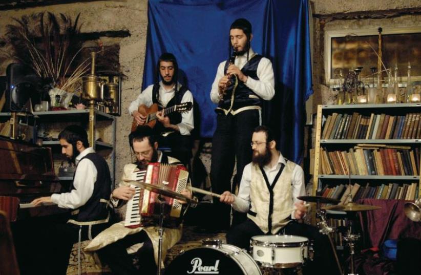 Avrum Lieb Burstein plays the accordion with a klezmer band at Burstein’s Krechme (photo credit: LOULOU D’AKI)