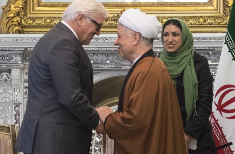 Chairman of Iran's Expediency Council Ali Akbar Hashemi Rafsanjani (R) shakes hands with German Foreign Minister Frank-Walter Steinmeier in Tehran (photo credit: REUTERS)