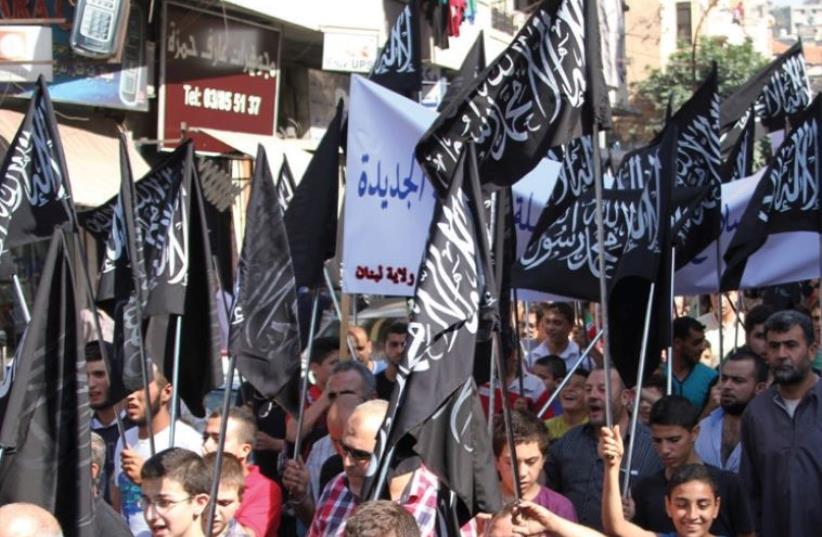 Members and supporters of the Islamist party Hizb Ut-Tahrir rally in Tripoli, northern Lebanon, in support of Palestinians and against Russian and US intervention in Syria, October 16 (photo credit: OMAR IBRAHIM / REUTERS)