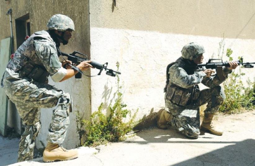 SPECIAL FORCES SOLDIERS drill recently in an urban environment that is part of the Elbit Combat Training System. (photo credit: ELBIT)