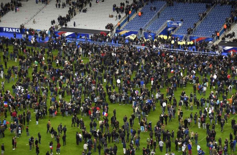 Soccer fans wait for security clearance to leave the Stade de France in Saint-Denis, north of Paris, after the friendly football match France vs Germany on November 13, 2015 (photo credit: PHOTO/FRANCK FIFE)