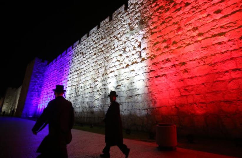 Wall of Jerusalem's old city lit up in colors of French flag (photo credit: MARC ISRAEL SELLEM/THE JERUSALEM POST)