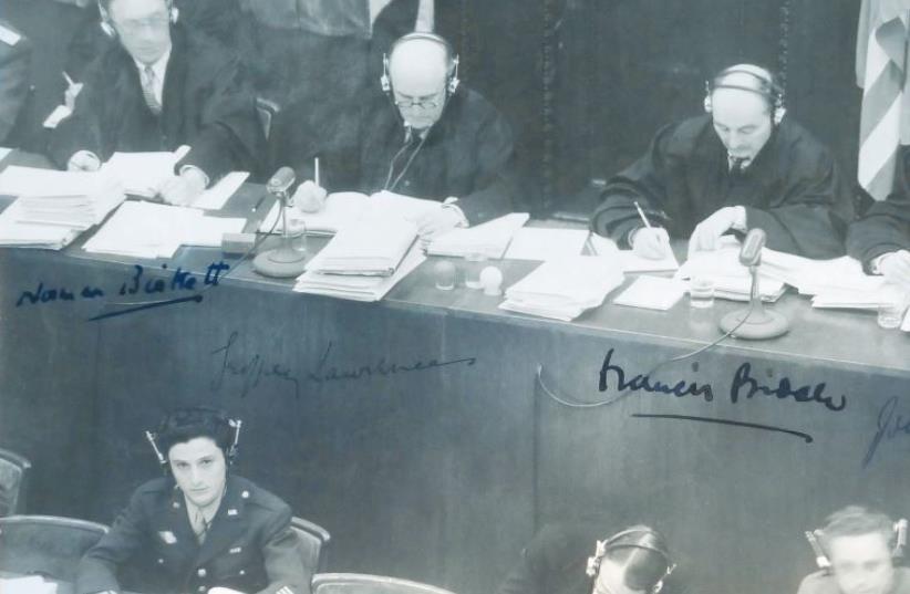 George Sakheim at left, in front of judges at Nuremberg Trial, 1946. The photo was signed by British and American judges (photo credit: COURTESY GEORGE SAKHEIM)