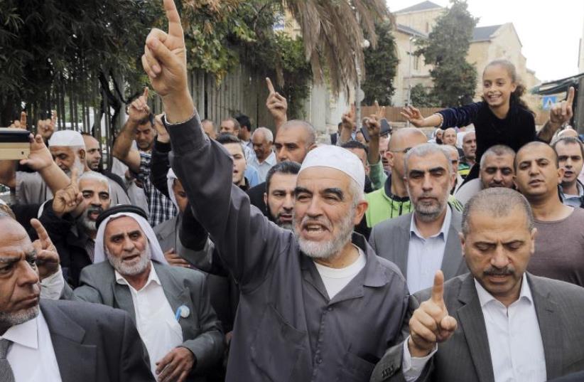 Leader of the northern Islamic Movement Sheikh Raed Salah gestures after leaving the district court in Jerusalem October 27, 2015. (photo credit: AMMAR AWAD/REUTERS)