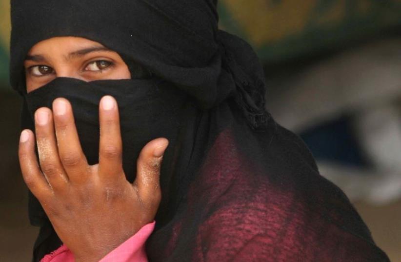 A Beduin woman from al-Aweida tribe sits next to her tent in north Sinai (photo credit: REUTERS)