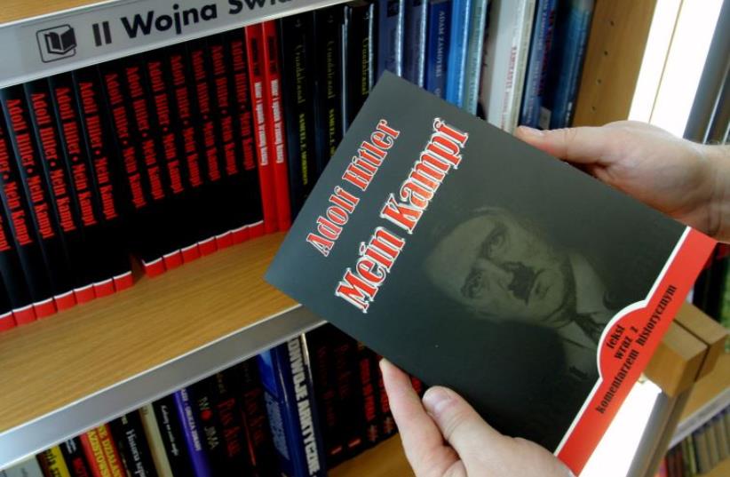 A customer holds a Polish copy of Adolf Hitler's Mein Kampf at a book store in Wroclaw, south western Poland February 23, 2005 (photo credit: REUTERS)