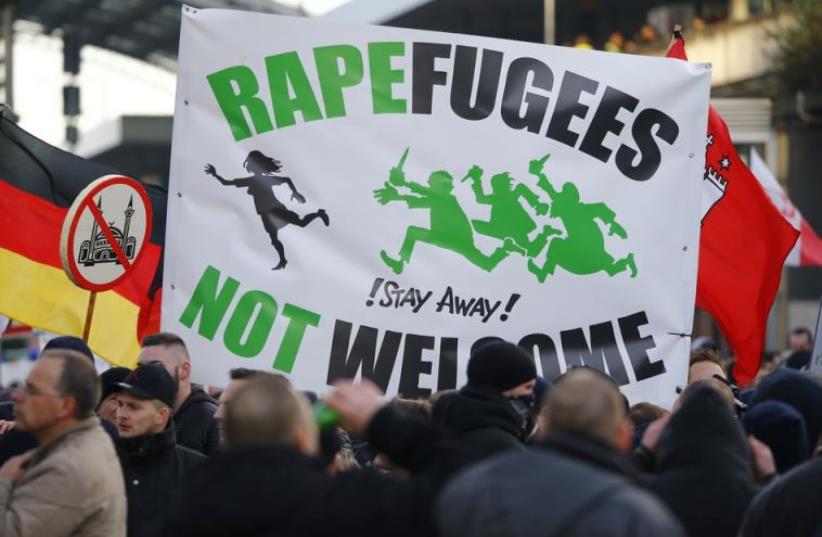 Supporters of anti-immigration right-wing movement PEGIDA (Patriotic Europeans Against the Islamization of the West) rally in Cologne (photo credit: REUTERS)