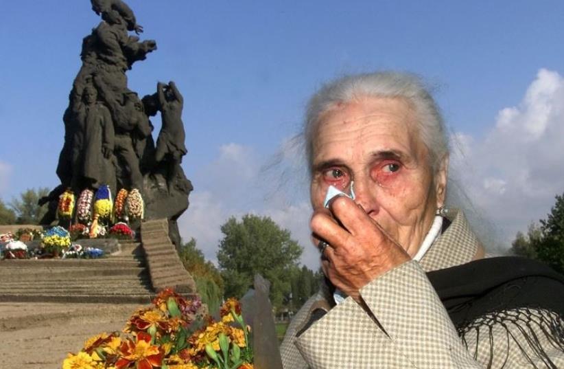 Ludmila Pynikh, 77, grieves during a mourning ceremony at Babi Yar in Kiev [File] (photo credit: REUTERS)