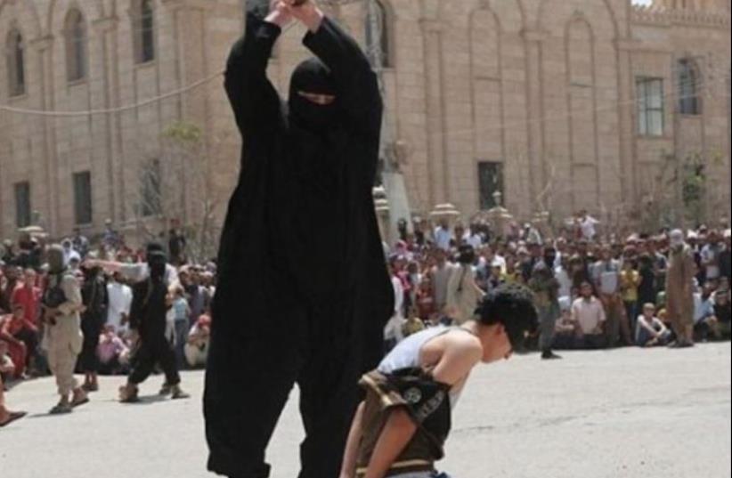 ISIS operative decapitates a young boy (photo credit: ARAB MEDIA)