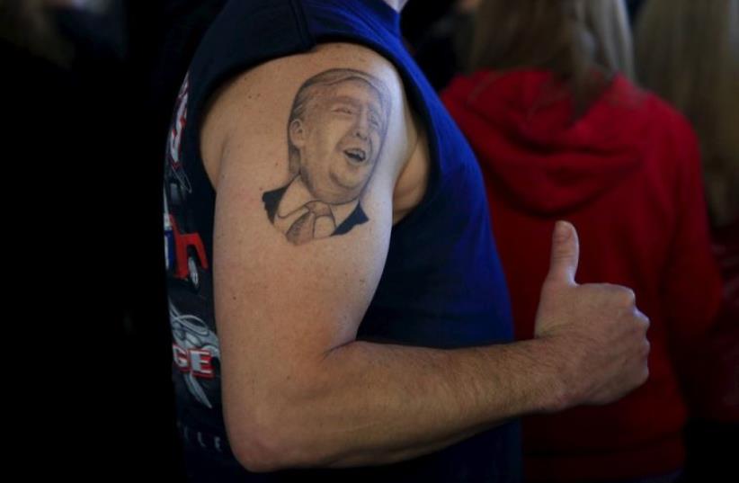 A supporter shows his tattoo before US Republican presidential candidate Donald Trump's campaign rally in Youngstown, Ohio (photo credit: REUTERS)