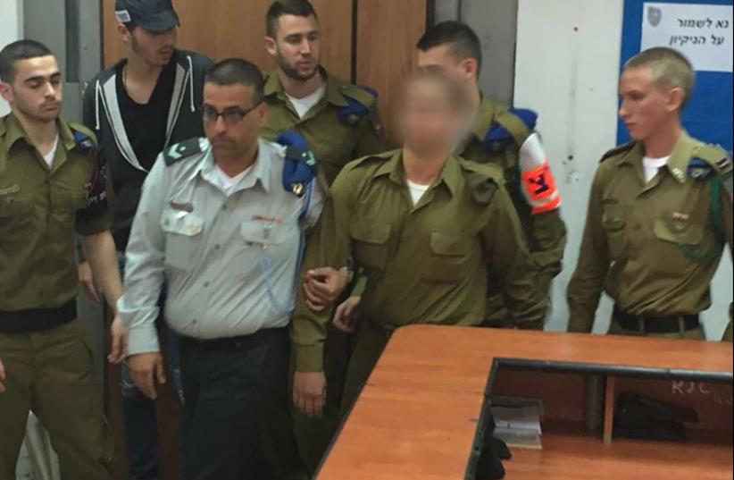 IDF soldier who shot a neutralized Palestinian terrorist in Hebron being led into court, March 29, 2016 (photo credit: NOAM AMIR)