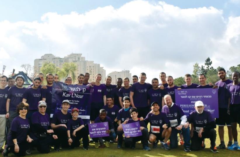 The Givati Brigade poses for a team photo with members of staff. Over 2,000 Givatis participated (photo credit: KAV L’NOAR)