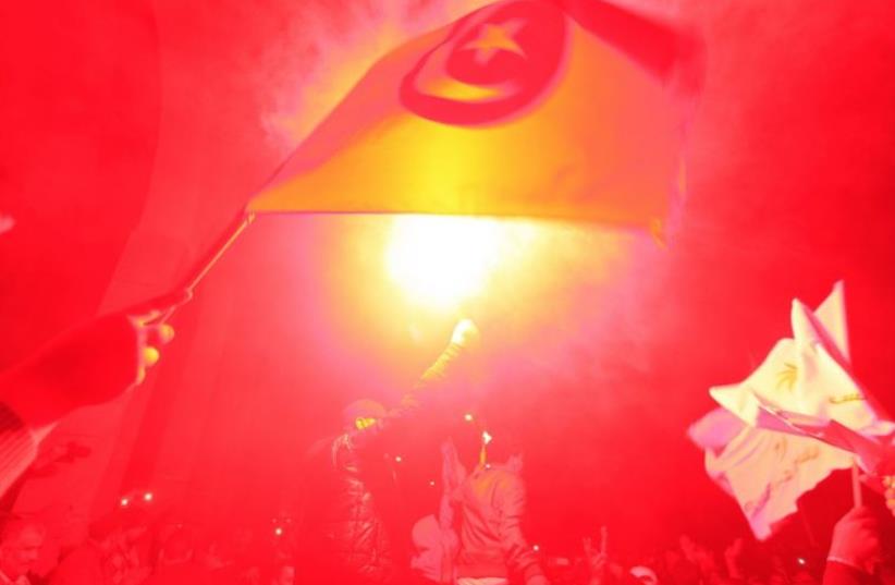 Tunisians celebrate an election nearly four years after an uprising ousted autocrat Zine El-Abidine Ben Ali (photo credit: REUTERS)