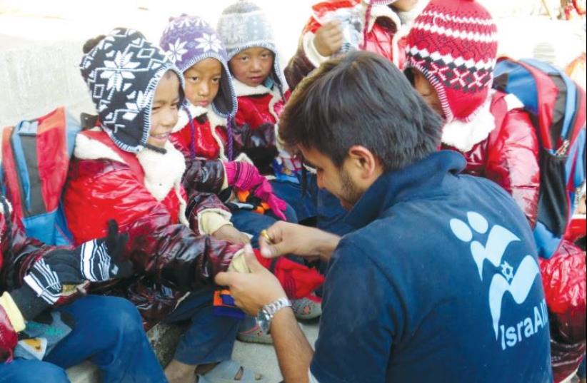 Israel and a partner NGO distributed warm clothing to 1,000 children in earthquake-affected communities of Nepal (photo credit: ISRAAID NEPAL)