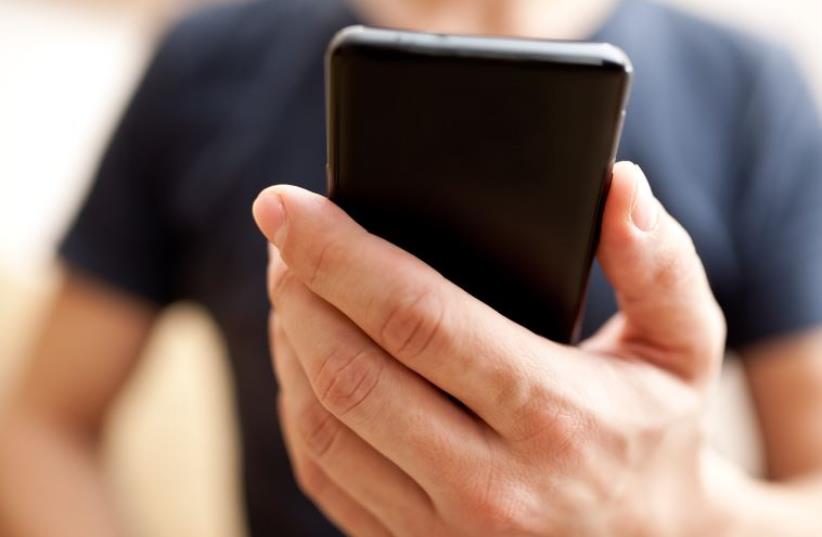 A man using mobile smartphone (photo credit: ING IMAGE/ASAP)