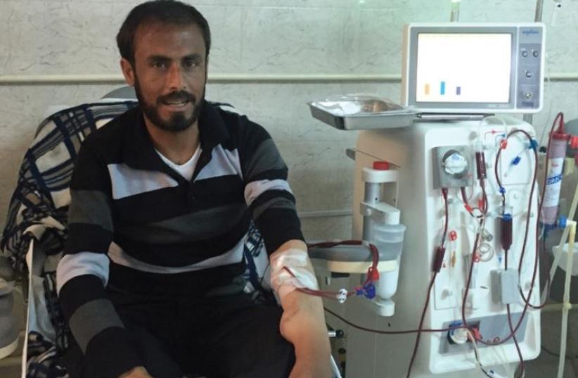 AHMED HAMZEH, a refugee from Deraa in Syria now living in Jordan’s Zaatari refugee camp, undergoes dialysis treatment yesterday at Irbid’s Islamic Hospital. (photo credit: SETH J. FRANTZMAN)