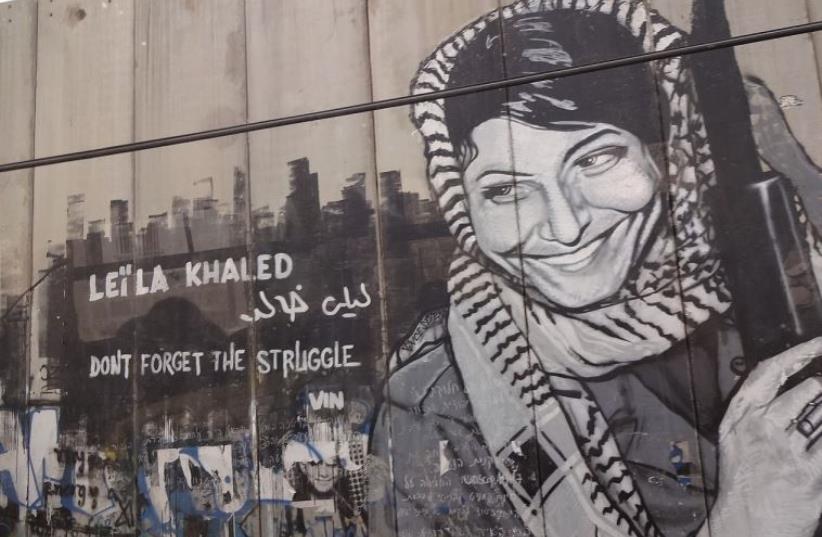 Graffiti depicting the PFPL plane hijacker Leila Khaled on the security barrier near Bethlehem (photo credit: Wikimedia Commons)