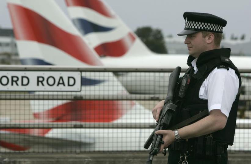 An armed policeman patrols Heathrow Airport, London (photo credit: REUTERS)