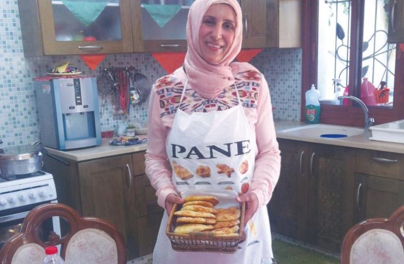 MANAL KARAMAL JEBEREEL, a private caterer, makes iftar meals for families in her home in Umm al-Fahm. (photo credit: LAURA KELLY)