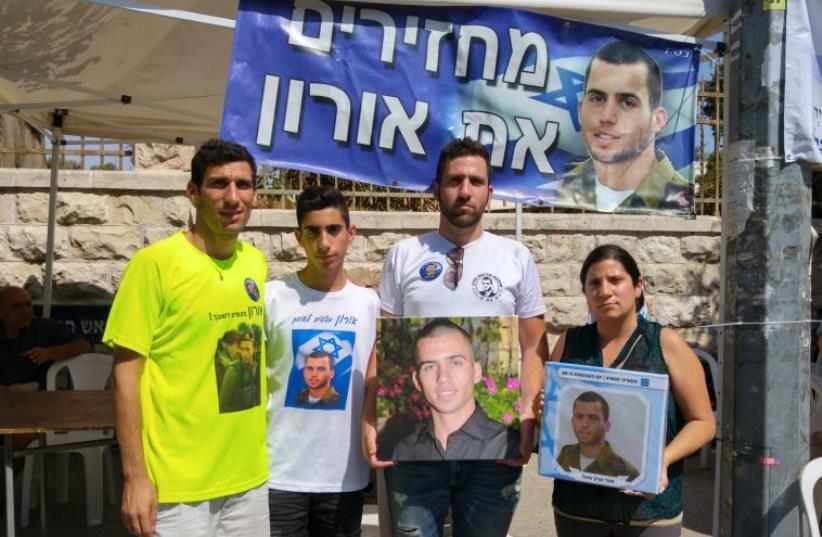 Family members of abducted soldier Oron Shaul demand his return in front of the Prime Minister’s Residence on Sunday (photo credit: DANIEL K. EISENBUD)