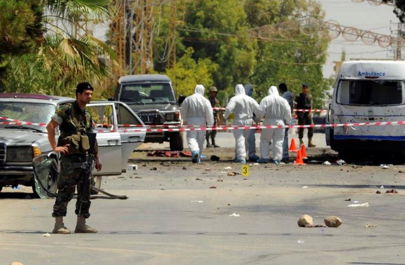 Lebanese army soldiers and forensic inspectors in Qaa (photo credit: REUTERS)