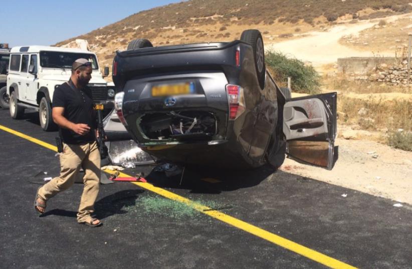 Shooting causes car to flip over on Route 60- July 1, 2016 (photo credit: FIRE AND RESCUE SERVICE)