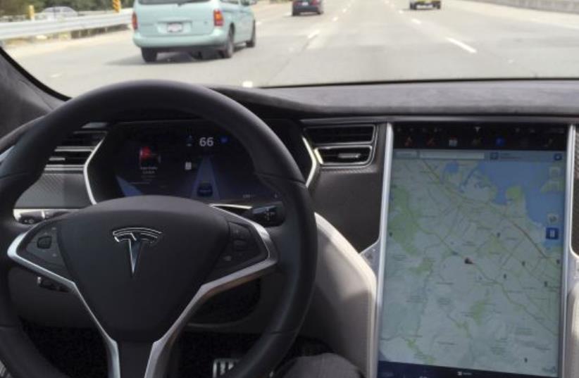 The interior of a Tesla Model S is shown in autopilot mode in San Francisco, California, U.S., April 7, 2016. (photo credit: REUTERS)