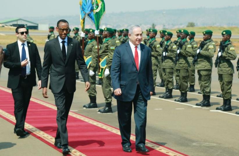 Prime Minister Benjamin Netanyahu walks alongside Rwandan President Paul Kagame in Kigali, Rwanda on July 6 (photo credit: REUTERS)