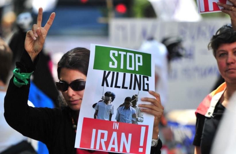 A demonstration against Iran's violation of gay rights during the Christopher Street Day (CSD) gay pride parade in Berlin [File] (photo credit: JOHANNES EISELE/AFP)