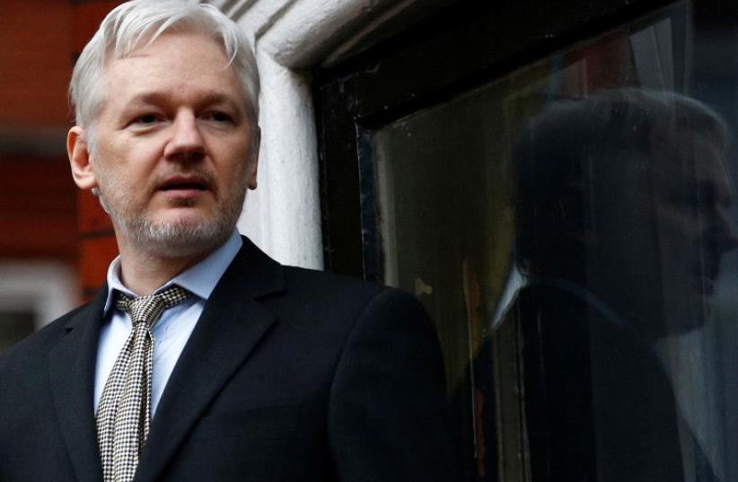 WikiLeaks founder Julian Assange makes a speech from the balcony of the Ecuadorian Embassy, in central London, Britain February 5, 2016. (photo credit: REUTERS)