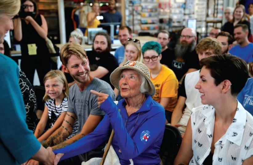 A WOMAN speaks with US Democratic presidential nominee Hillary Clinton earlier this week in Iowa. (photo credit: REUTERS)