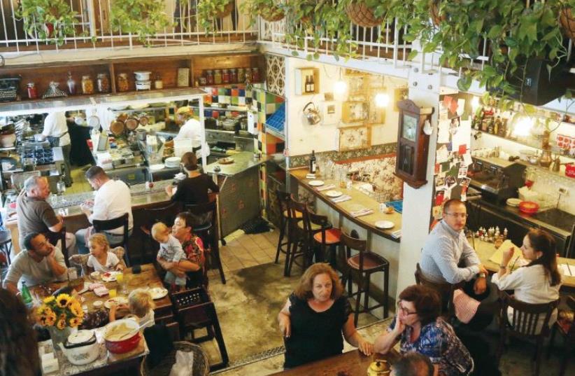 Diners enjoy a meal at the Machneyuda restaurant (non-kosher) in Jerusalem (photo credit: MARC ISRAEL SELLEM)