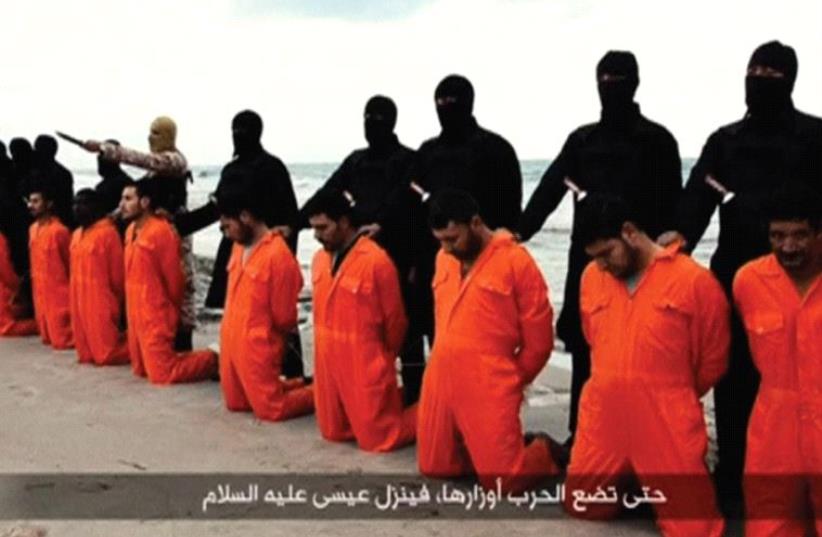 ISIS TERRORISTS pose on a Libyan beach in February 2015 with 21 captured Egyptian Christians they are about to behead (photo credit: REUTERS)