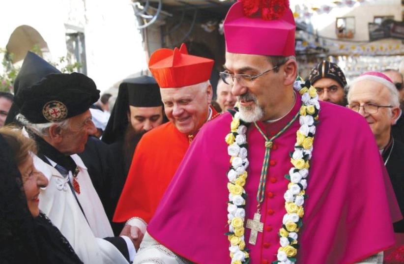 PIERBATTISTA PIZZABALLA shakes hands with a well-wisher in the Old City (photo credit: REUTERS)